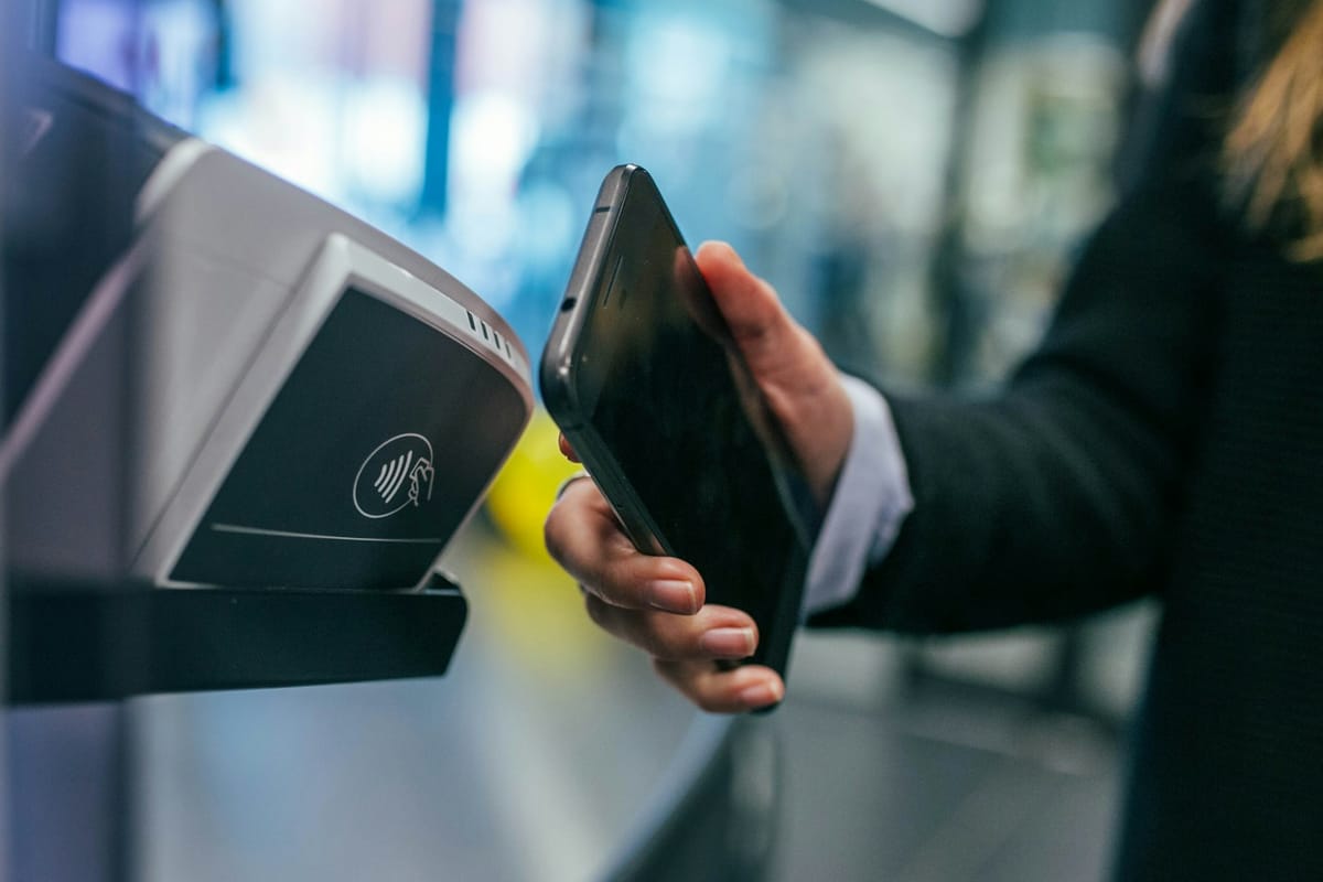 A phone held over a payment terminal